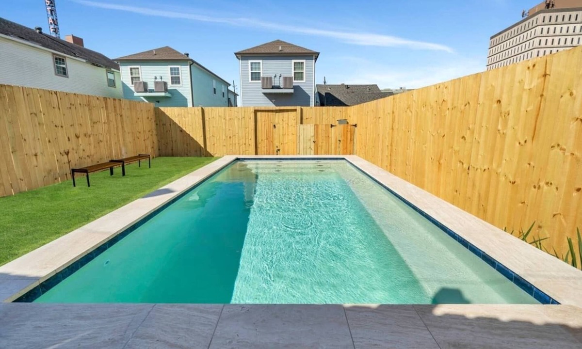 Tulane - Gravier Apartment | Modern 4BR Mid-City home with heated pool & balcony. Free parking, walk to streetcar & parades.