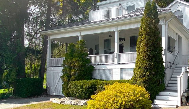 Heritage style cottage with lake view, perfect porch for family gatherings.