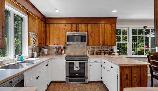 Romantic colonial in beach town situated on park-like private 8 acres with pool.
