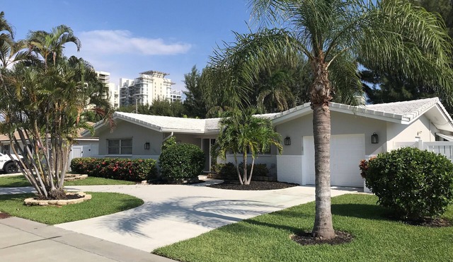 Single open-concept home one block from the ocean with heated pool and lanai